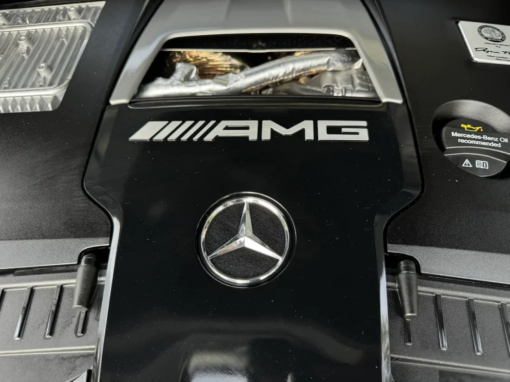 2024 Mercedes-Benz GLE 63 S AMG engine bay showing handcrafted V8 Biturbo engine with AMG branding.