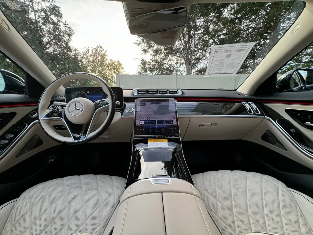 Dashboard and steering view of the 2024 Mercedes-Benz S580 showcasing digital screens and luxury details.