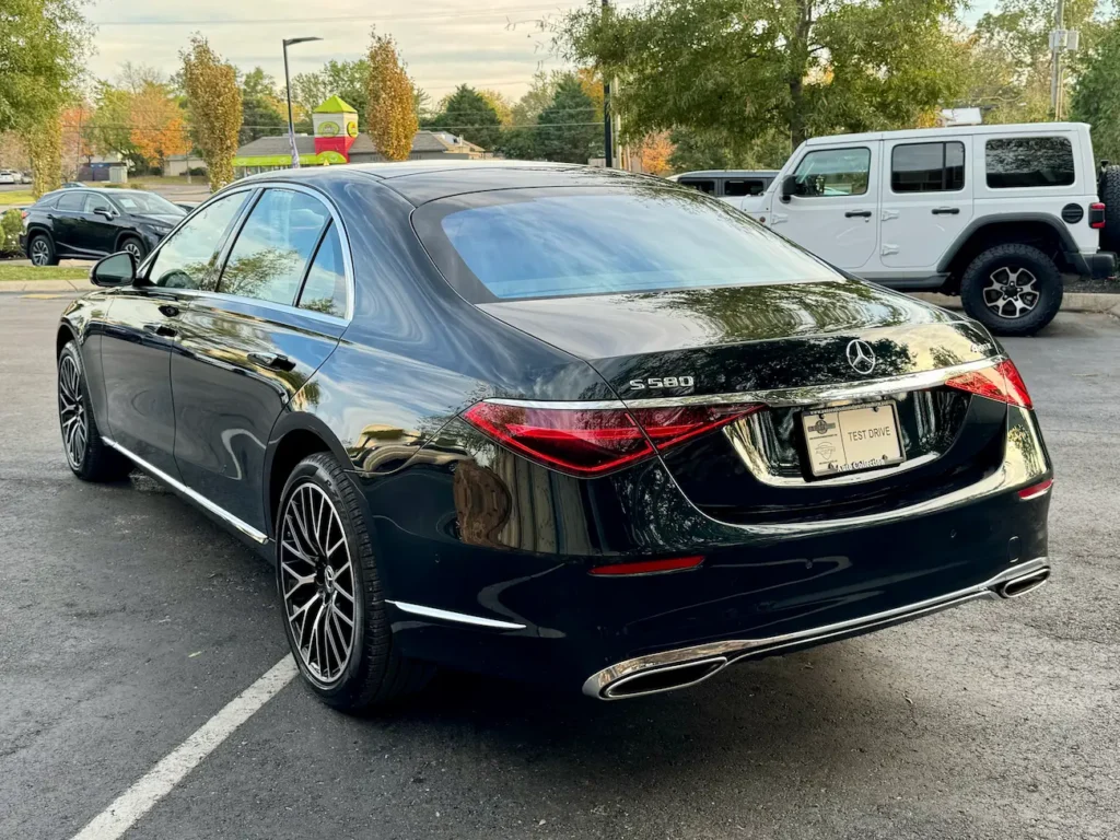 Rear view of the 2024 Mercedes-Benz S580 in green highlighting sculpted tail lights and chrome details.