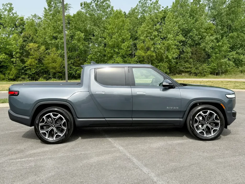 Side view of a gray 2024 Rivian R1T electric pickup with truck bed
