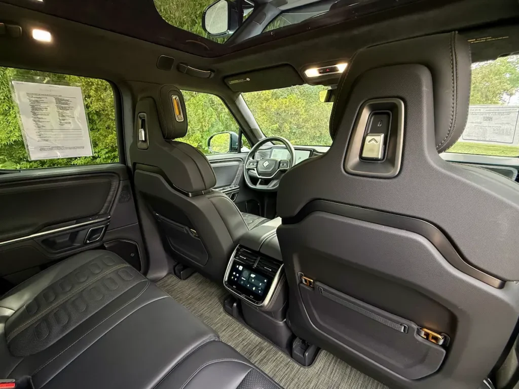 Rear-seat area inside a 2024 Rivian R1T with rear touchscreen controls