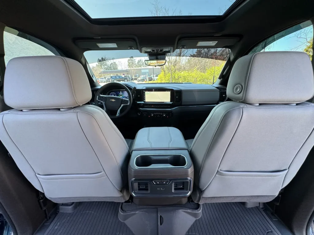 Interior view of the 2024 Chevrolet Silverado 2500HD LTZ showing gray leather seats, digital dashboard, and panoramic sunroof.
