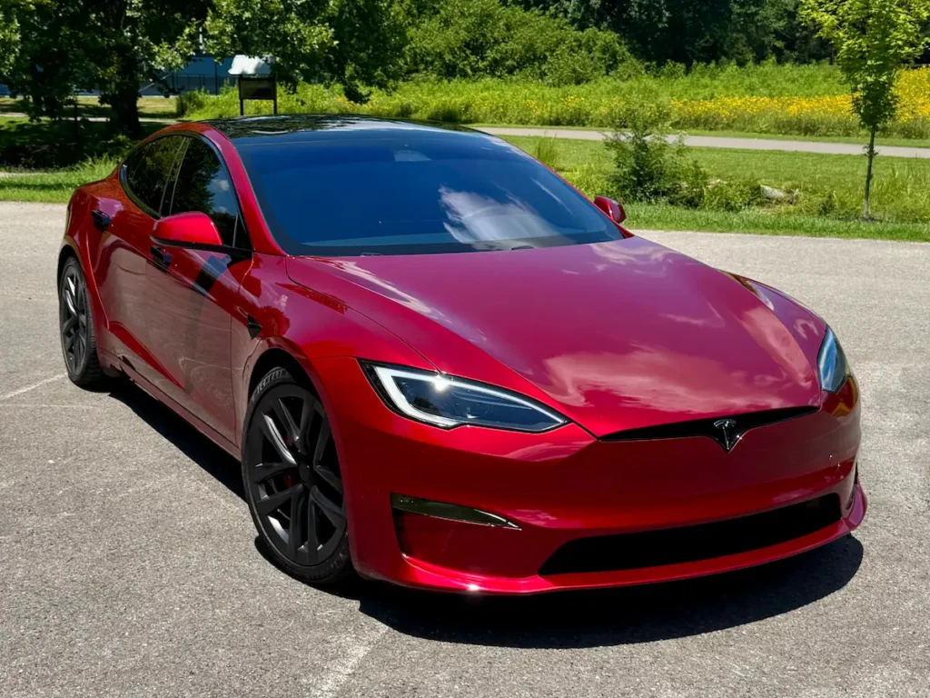 Red 2024 Tesla Model S Plaid luxury electric sedan shown from the front exterior angle