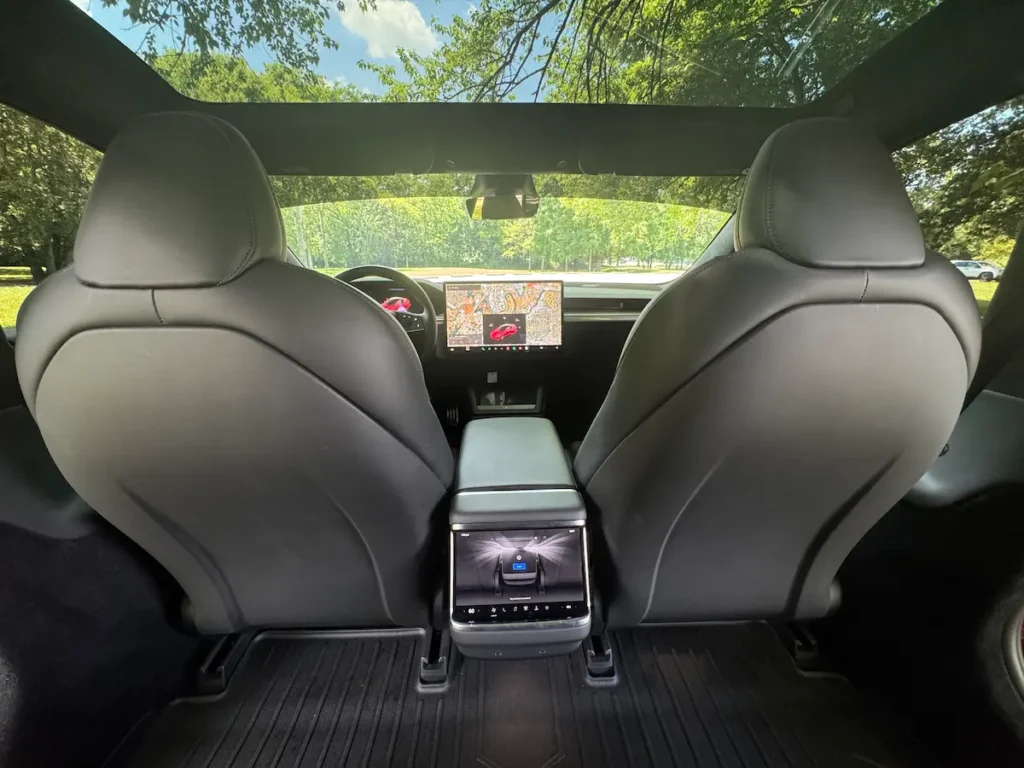 Rear seat interior of 2024 Tesla Model S Plaid with panoramic glass roof