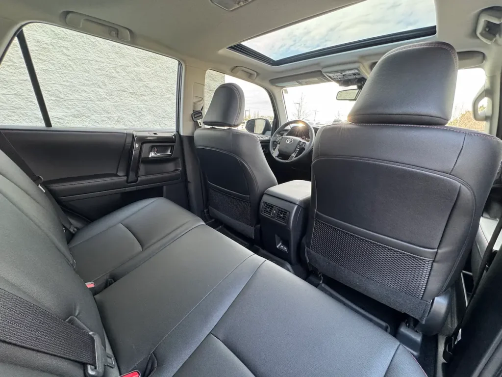 Rear passenger seating in a 2024 Toyota 4Runner with black upholstery and a sunroof.