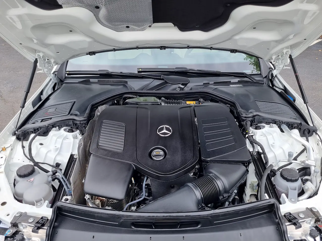 ngine bay of a 2024 Mercedes-Benz C 300 featuring a 2.0-liter turbo mild-hybrid engine.