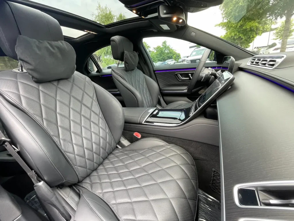 Front seats of the 2024 Mercedes-Benz S580e with elegant stitching and ergonomic design.