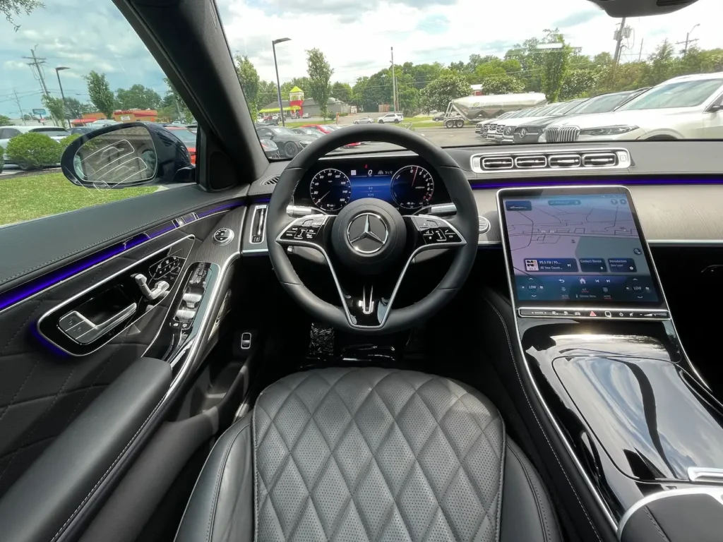 Interior view of the 2024 Mercedes-Benz S580e with quilted leather seats and ambient lighting