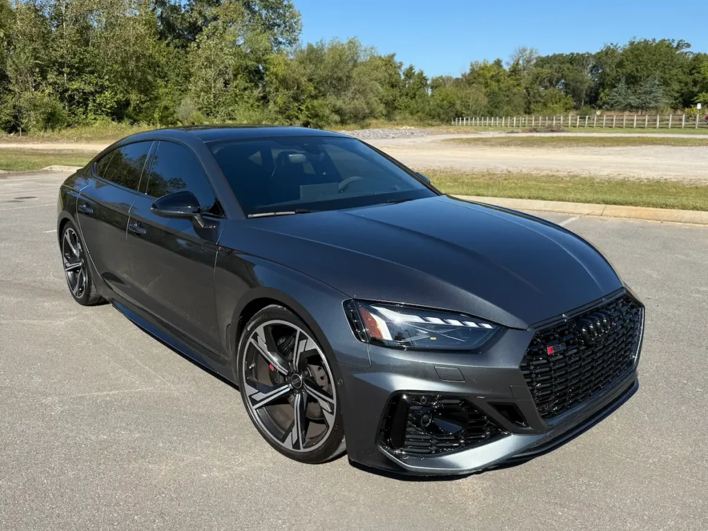 2025 Audi RS5 Sportback in gray shown from the front with aggressive grille and LED headlights.