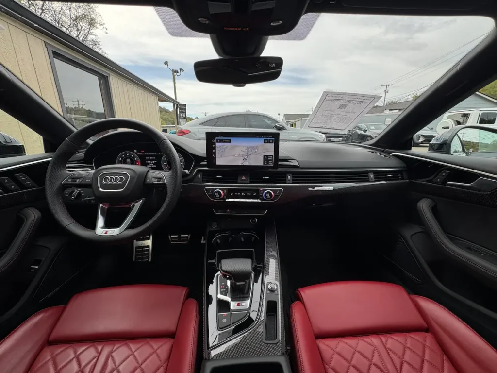 2025 Audi S5 interior with red leather seats and digital display