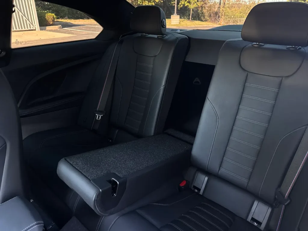 BMW M2 rear seats interior showing compact rear seating and folded center armrest