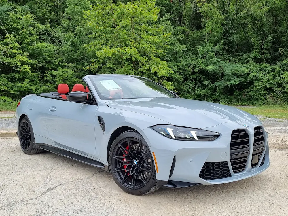 gray BMW M4 Competition convertible with red interior parked outdoors