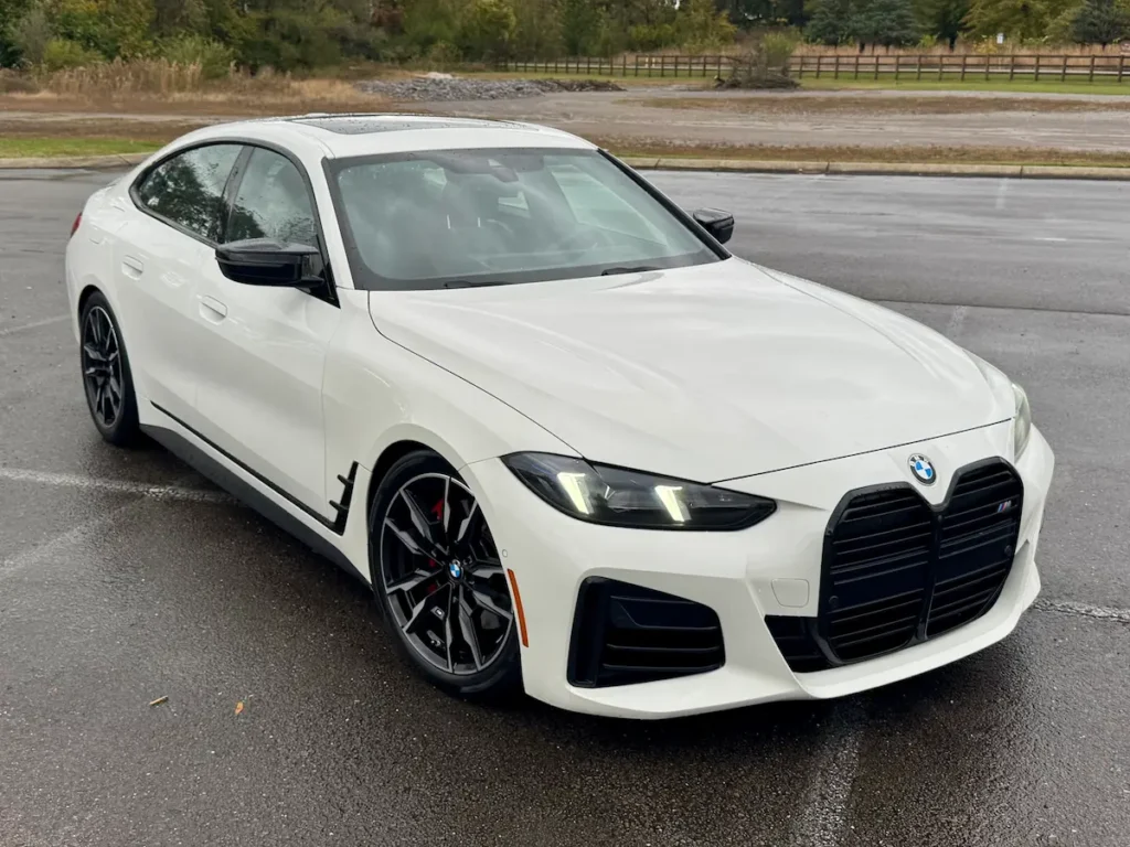 2025 BMW M440i Gran Coupe in white with sporty M bumpers and LED lighting.