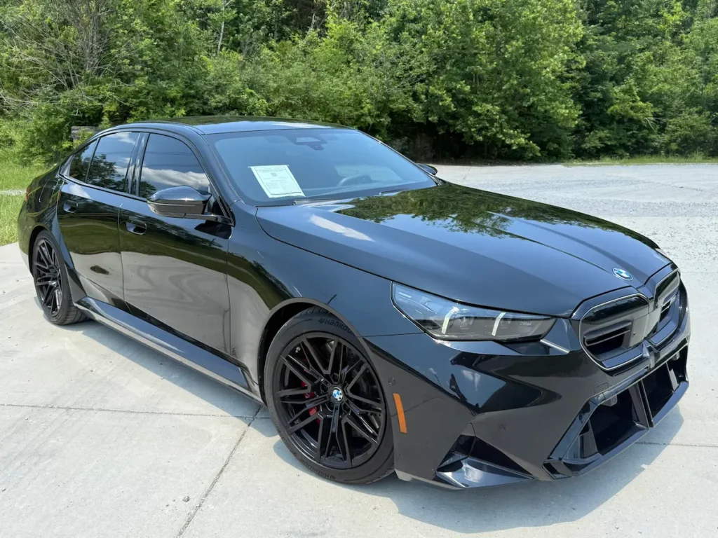 2025 BMW M5 black front exterior, used high-performance luxury sedan example