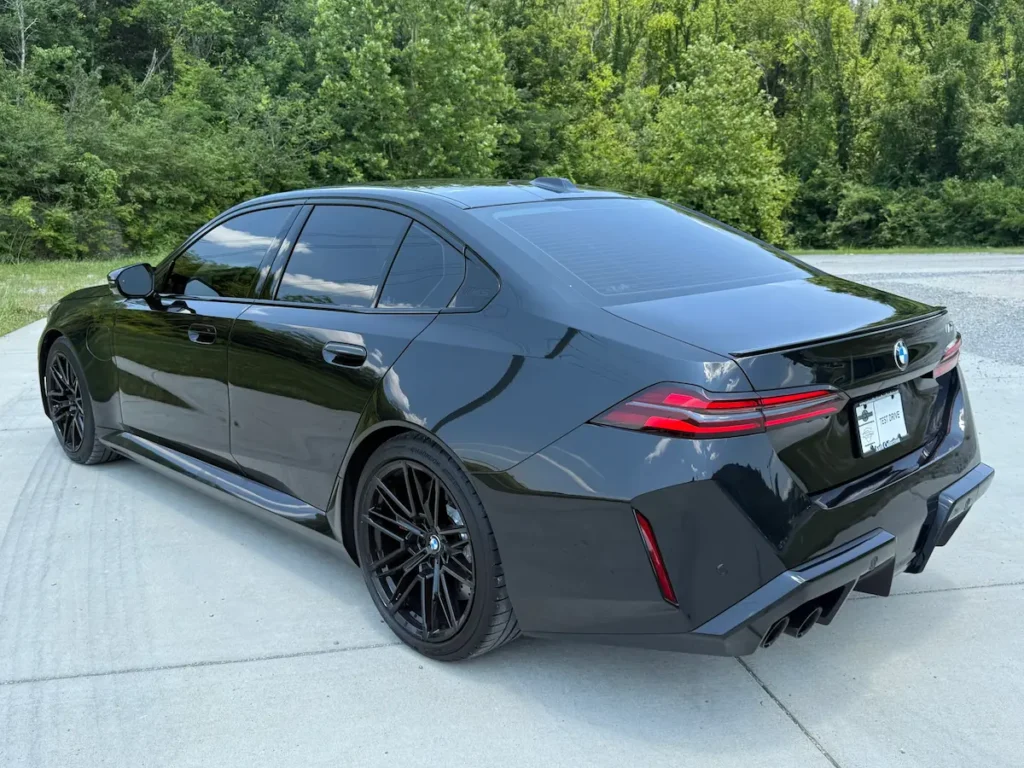 2025 BMW M5 black rear exterior, luxury performance sedan with four-door usability