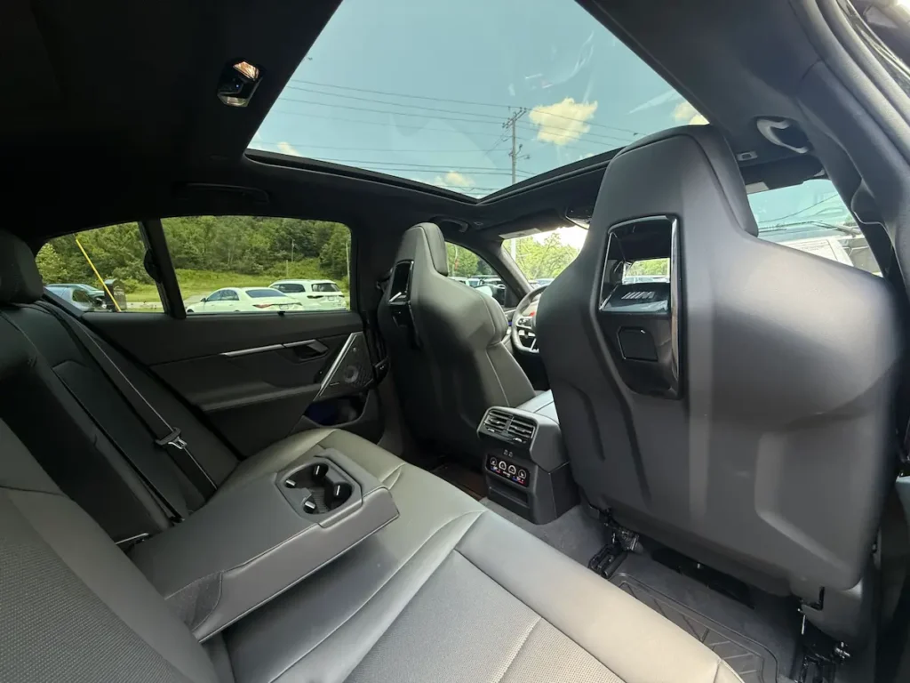2025 BMW M5 rear seats with luxury sedan passenger space and panoramic roof