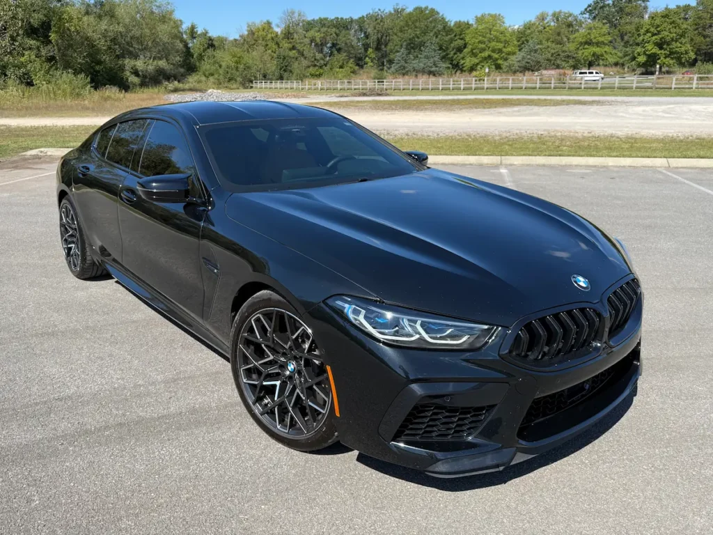 2025 BMW M8 Gran Coupe in black with aggressive front fascia and M-performance styling.