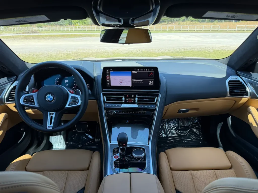 2025 BMW M8 cockpit with premium leather, digital controls, and M steering wheel.