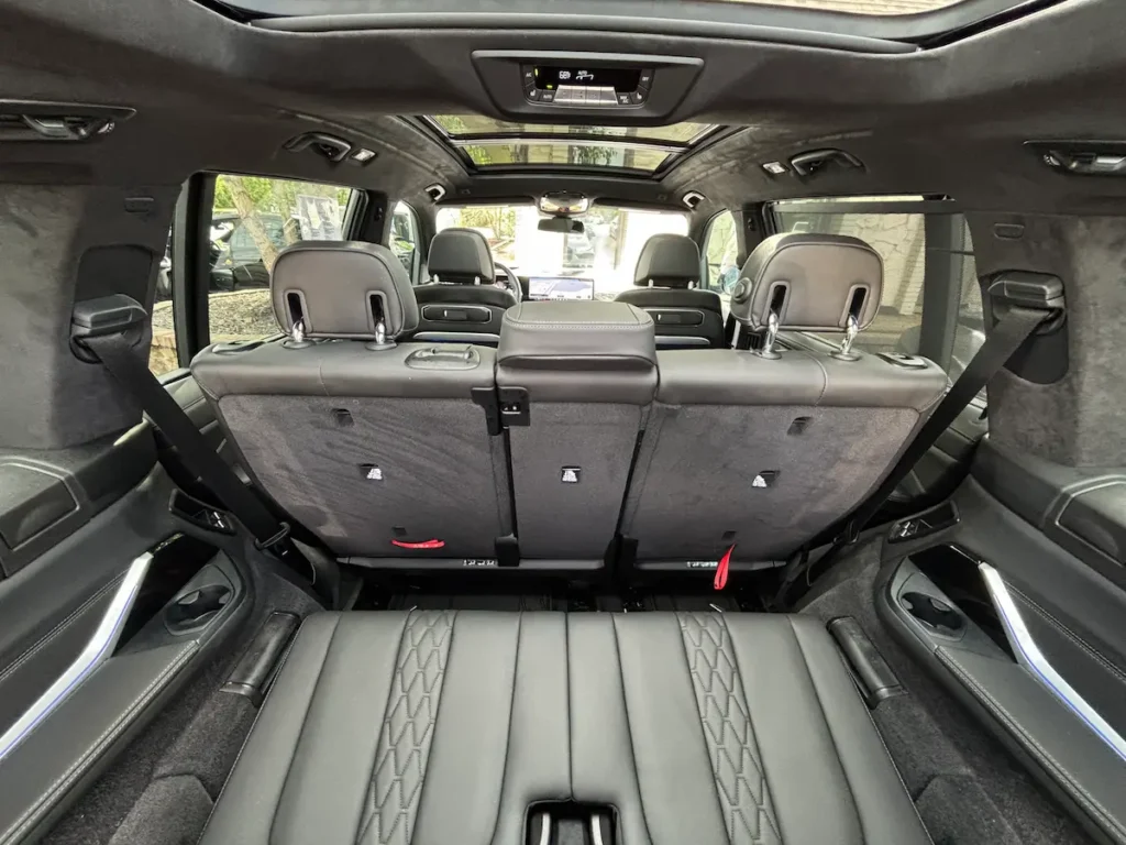 2025 BMW X7 M60i rear seating and cargo-area view inside the three-row luxury SUV