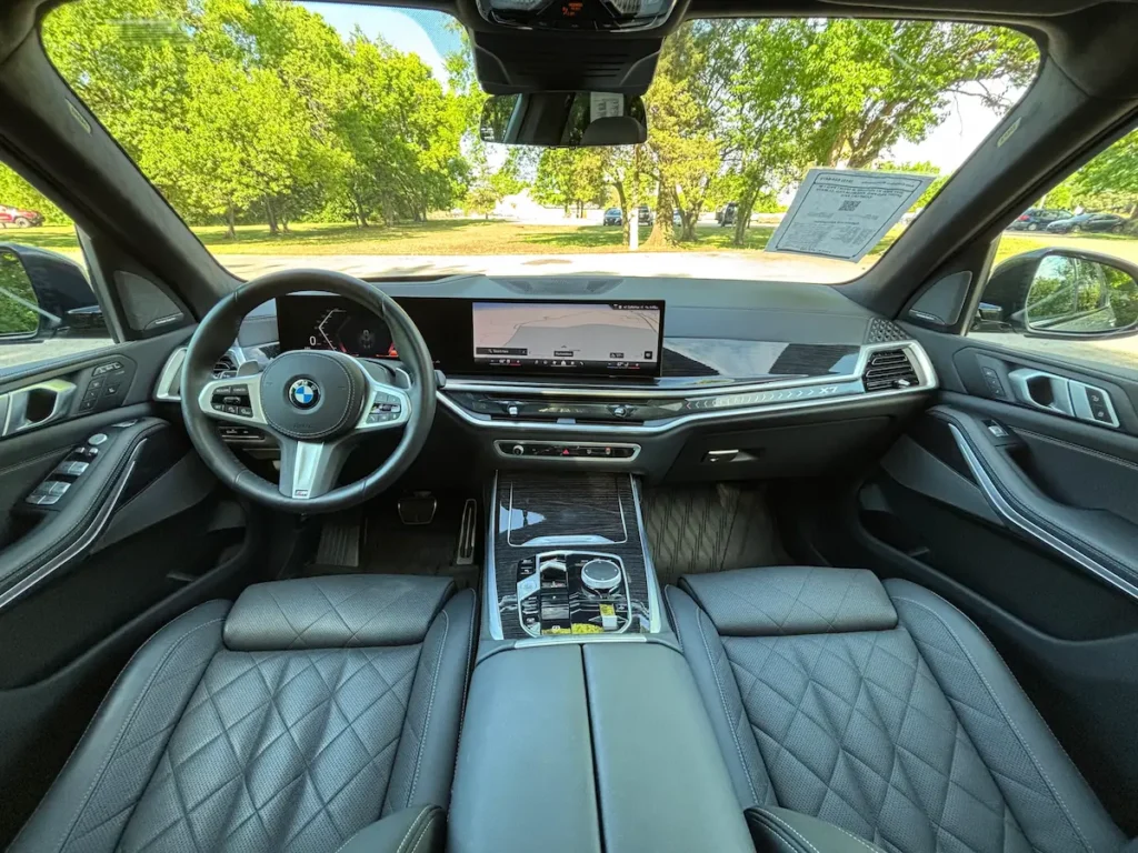 2025 BMW X7 interior with luxury front seats and digital dashboard