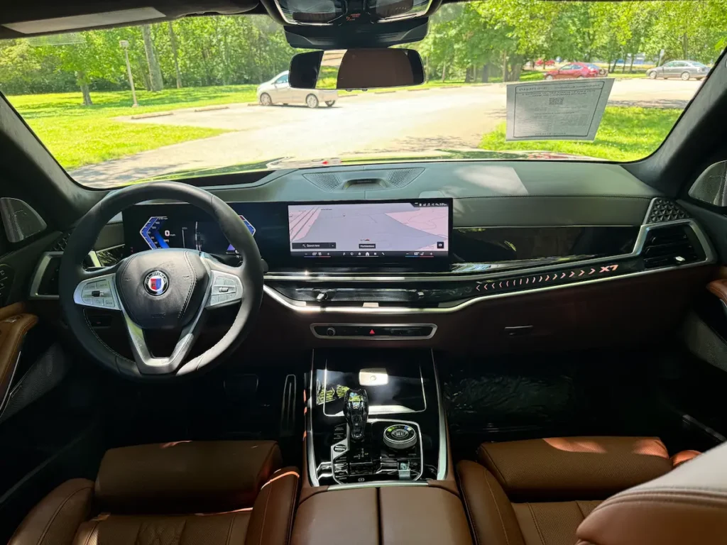 2025 BMW XB7 Alpina interior front cabin with leather seats, digital dash, and Alpina details.