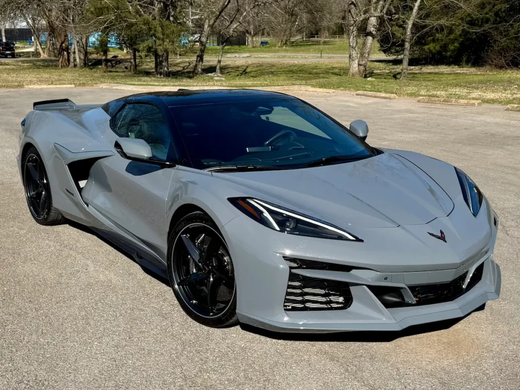 Side and front angle of a gray 2025 Chevrolet Corvette E-Ray 3LZ with black roof and carbon flash wheels.