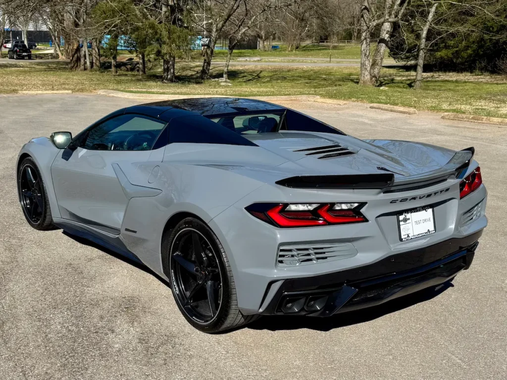 Rear angle of a 2025 Chevrolet Corvette E-Ray 3LZ with black aero trim and signature LED taillights.