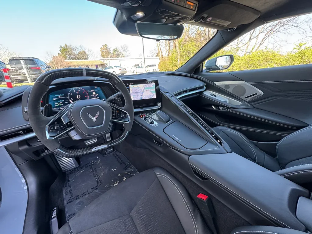 Interior cockpit of a 2025 Chevrolet Corvette E-Ray 3LZ with black leather and digital displays.