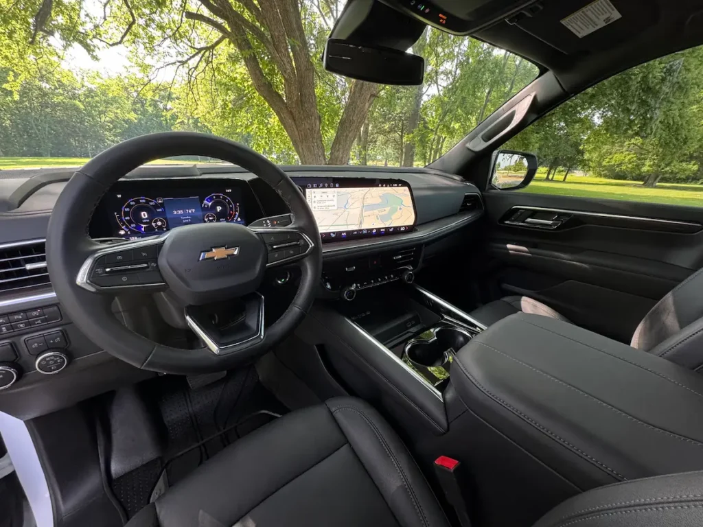 Front interior of a 2025 Chevrolet Tahoe LT with digital driver display and large touchscreen.