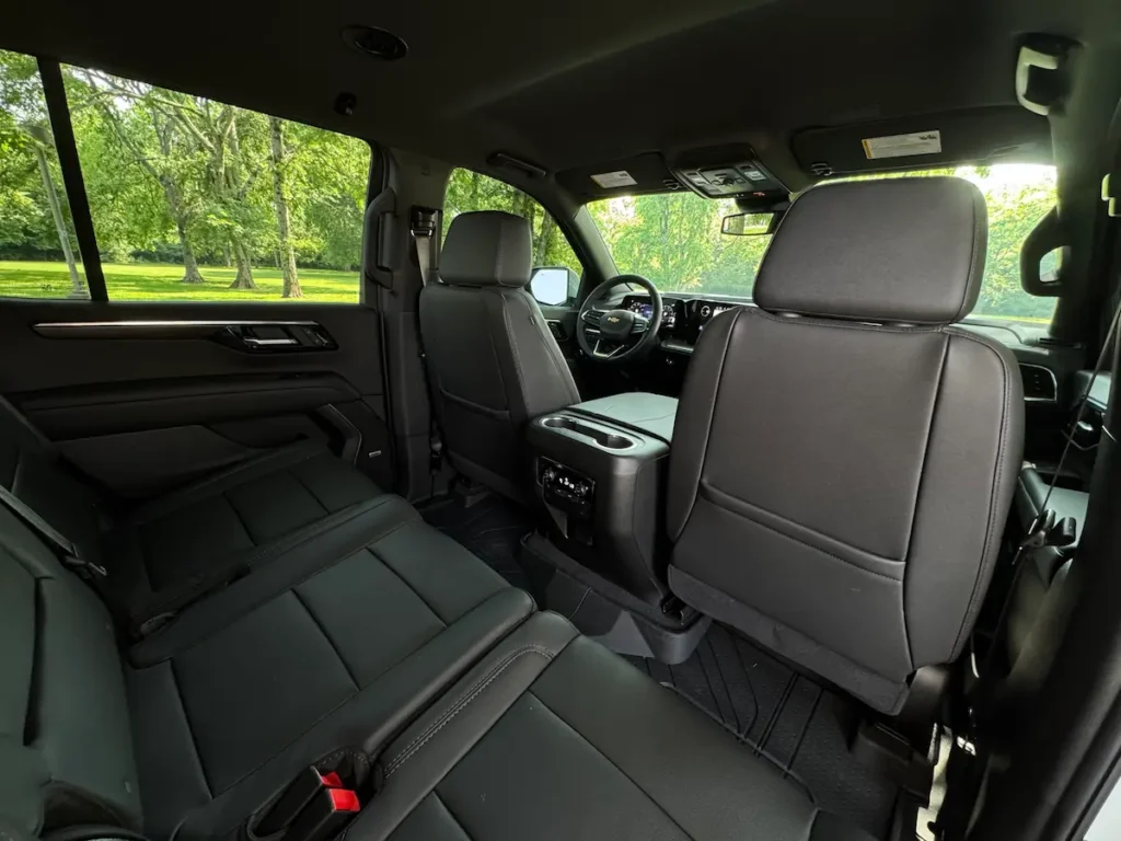 Rear cabin view of a 2025 Chevrolet Tahoe LT showing spacious black leather second-row seating.