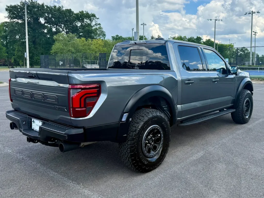 Rear three-quarter view of a gray 2025 Ford F-150 Raptor