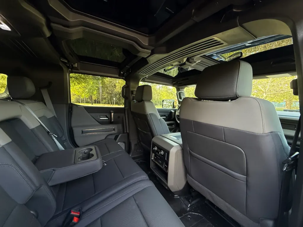 Rear seating and removable roof panel view inside a 2025 GMC Hummer EV 3X SUV.