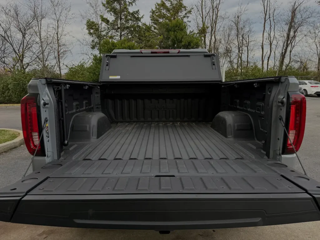 Open truck bed of a 2025 GMC Sierra 1500 AT4 with spray-in liner and MultiPro tailgate.