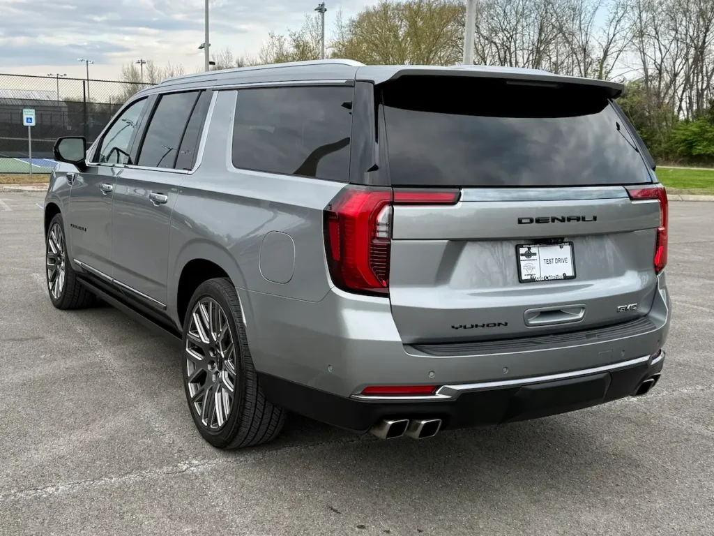 Rear three-quarter view of a gray 2025 GMC Yukon XL Denali Ultimate