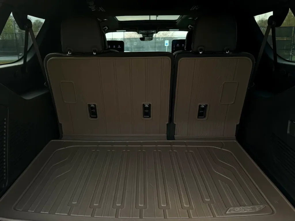 Cargo area of a gray 2025 GMC Yukon XL Denali Ultimate with the third-row seats upright