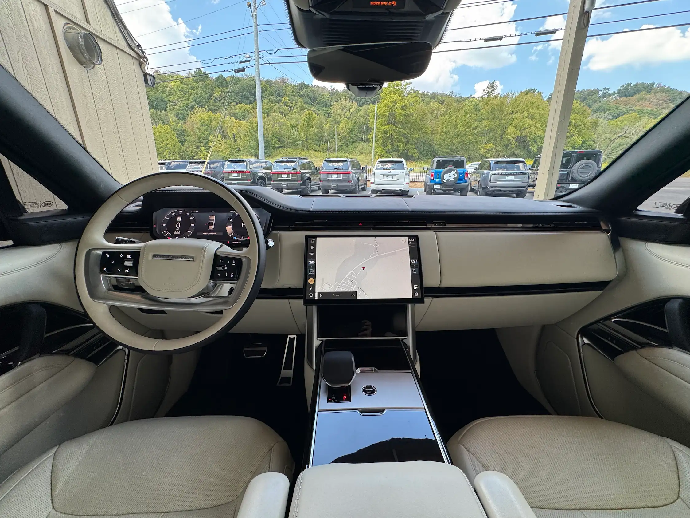 2025 Range Rover P530 SE dashboard with light trim, a central touchscreen, digital instruments and glossy center console.