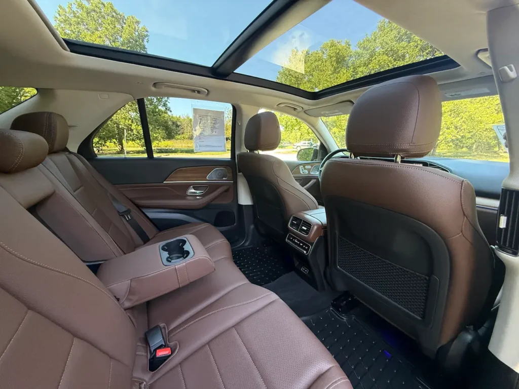 Rear seats of 2025 Mercedes-Benz GLE 350 with brown leather and panoramic sunroof.