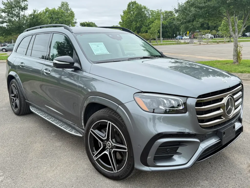 Front exterior of 2025 Mercedes-Benz GLS 450 in sleek grey with chrome grille and LED headlights.