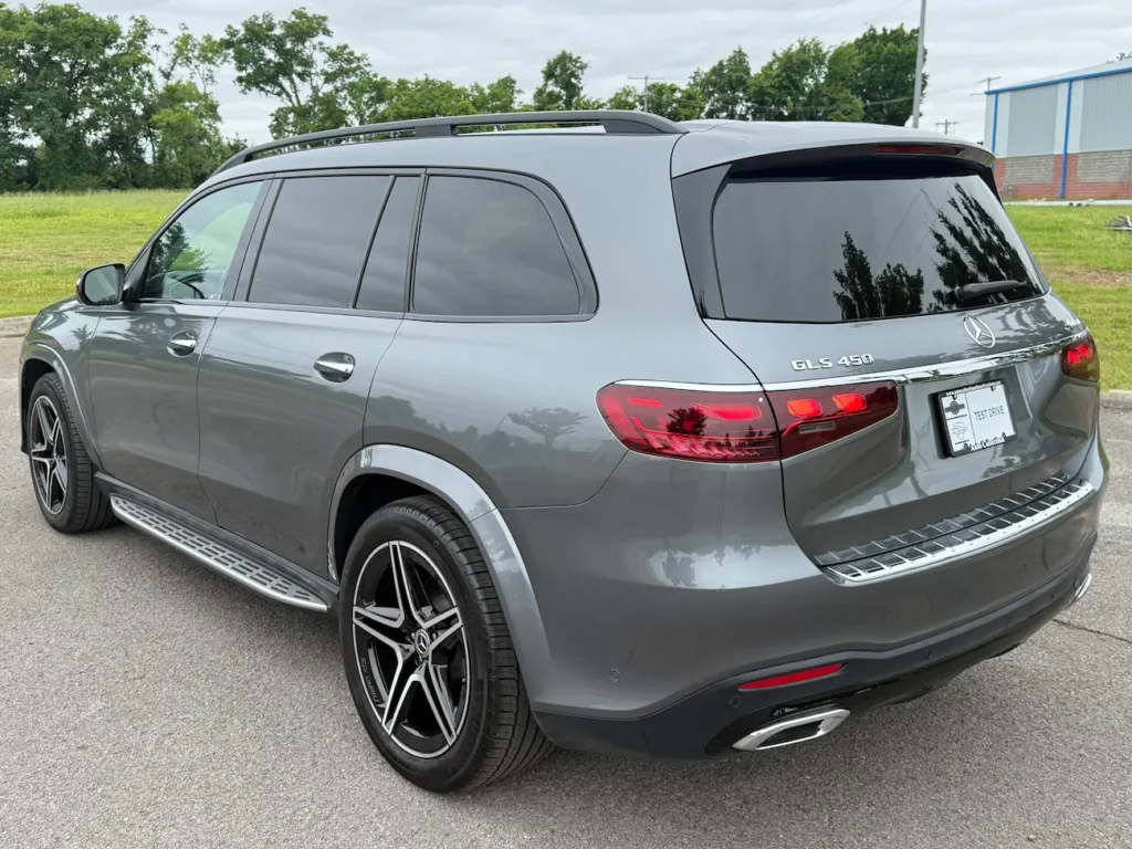Rear view of 2025 Mercedes-Benz GLS 450 grey SUV with LED taillights and chrome accents.
