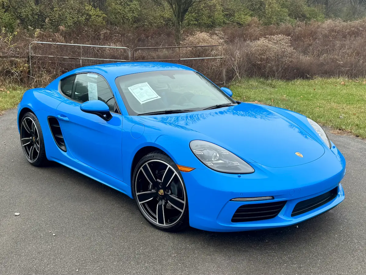 Blue 2025 Porsche 718 Cayman with black and silver wheels