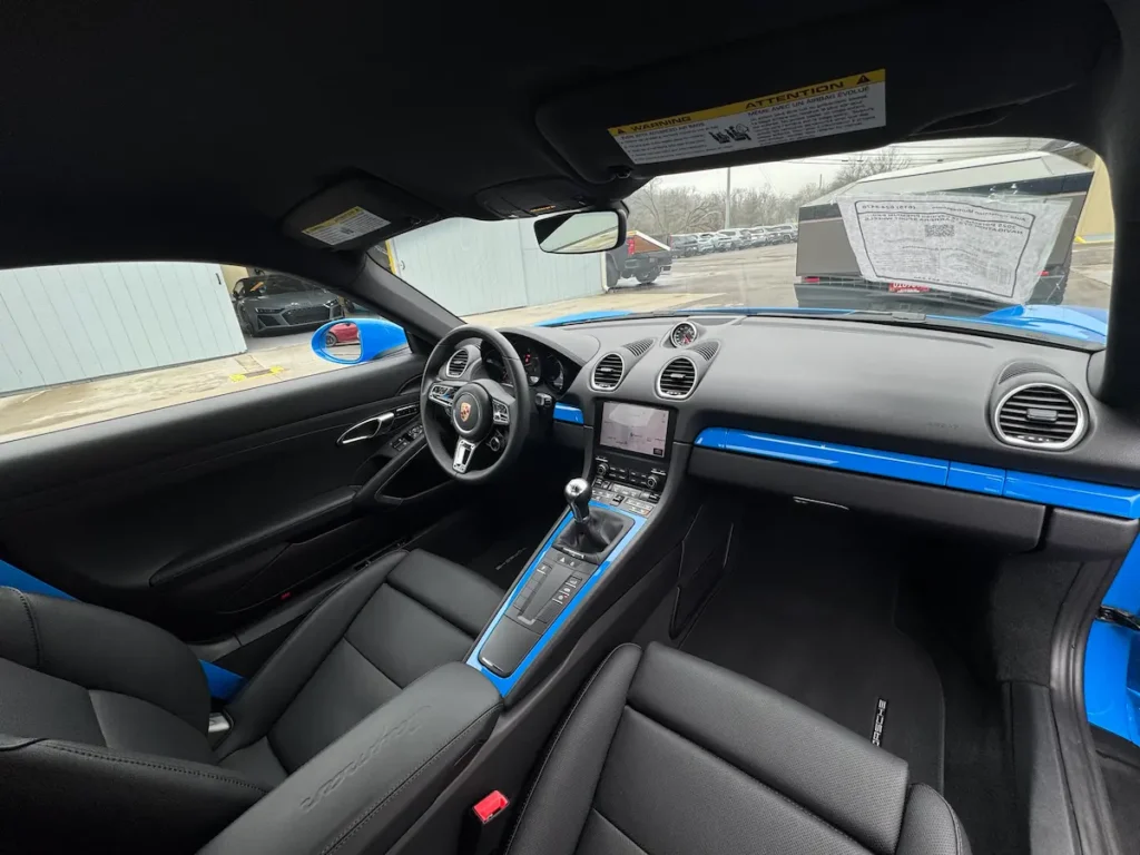 2025 Porsche 718 Cayman interior with manual transmission and sport cabin
