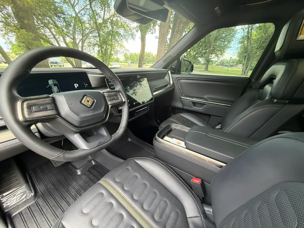 Front cabin of a 2025 Rivian R1S with steering wheel and central touchscreen
