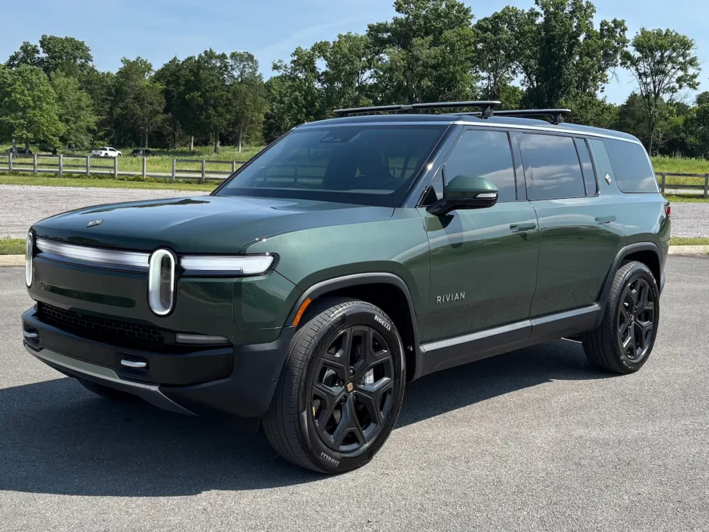 Green 2025 Rivian R1S electric SUV shown from the front three-quarter angle