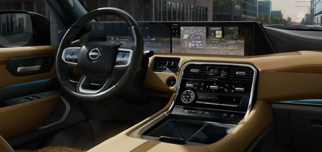 Interior of the 2025 Nissan Armada Platinum Reserve Edition featuring dual digital displays, a premium leather dashboard, and a modern infotainment system.