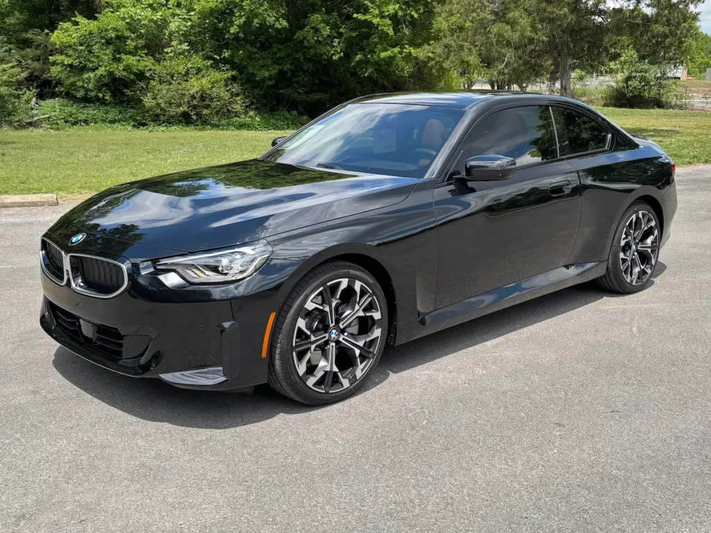 2026 BMW 230i black coupe front exterior view with sporty wheels