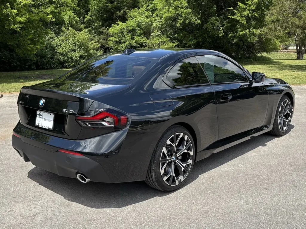 2026 BMW 230i black coupe rear view with sporty exterior design