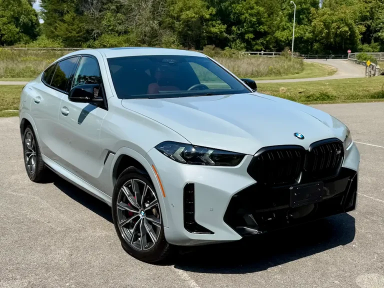 gray BMW X6 midsize SUV with coupe-like roofline parked in sunlight