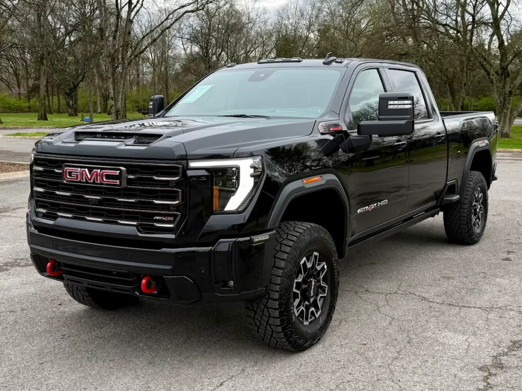 Front three-quarter view of a black 2026 GMC Sierra 2500HD AT4X