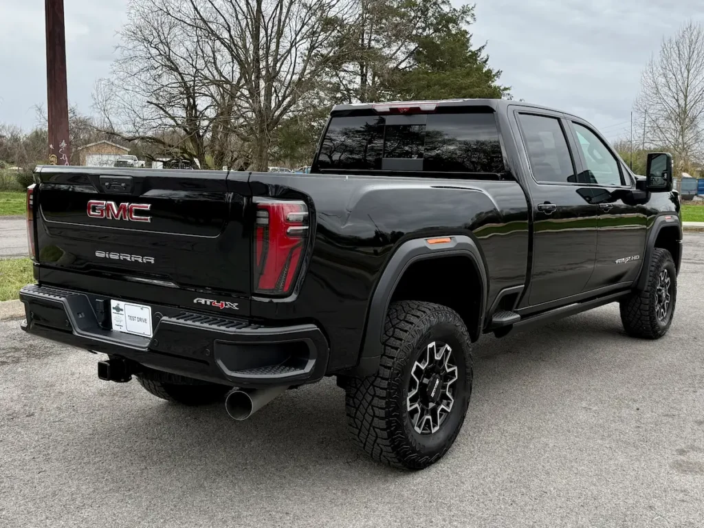 Rear three-quarter view of a black 2026 GMC Sierra 2500HD AT4X