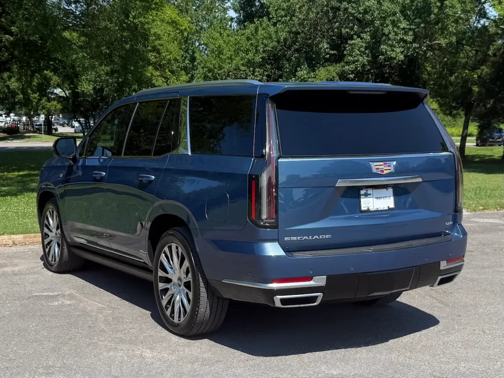 Rear three-quarter view of a blue 2026 Cadillac Escalade full-size luxury SUV